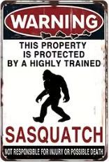 A fun metal sign that says property I protected by Sasquatch
