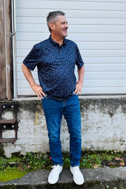 Flag & Anthem men's polo at Bigfoot Mountain Outfitters. This is a modern twist on a classic polo with its vibrant floral and cocktail themed print. Made for comfort and versatility that has performance ready fabric  that is perfect for any social occasion, golf or a night out!
