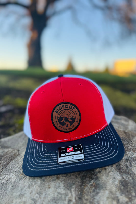 Bigfoot Mountain Outfitters original patch logo mesh back hat in Red/Navy/White, a casual classic trucker hat for sunny days on the water, road trips, festivals and everyday wear