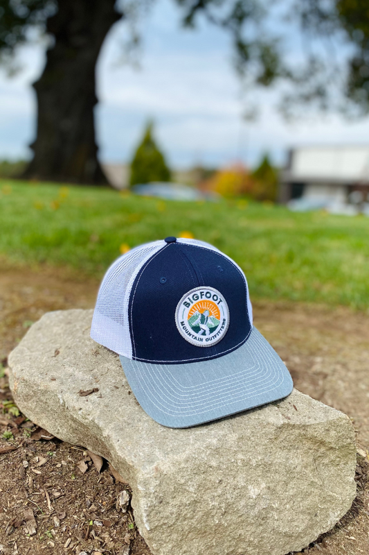Bigfoot Mountain Outfitters original patch logo mesh back hat in Navy/Charcoal/White, a casual classic trucker hat for sunny days on the water, road trips, festivals and everyday wear